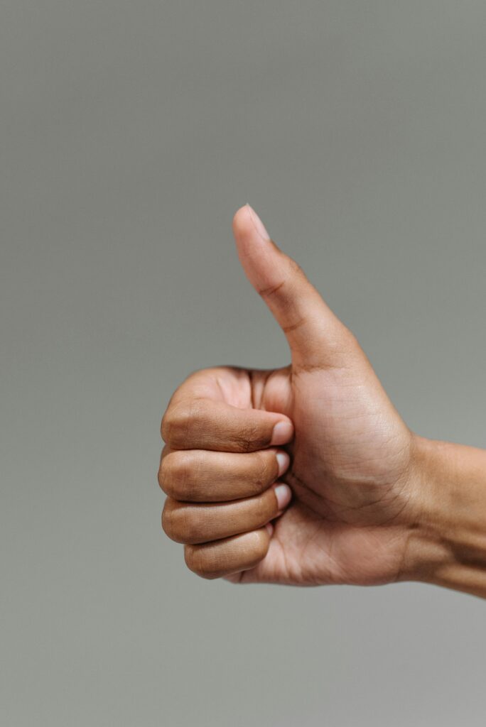 pexels-photo-9486674-9486674 A close-up of a hand showing a thumbs up gesture, symbolizing success and approval.